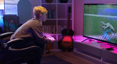 Kid on Xbox Playing Football Game with Pink Valore