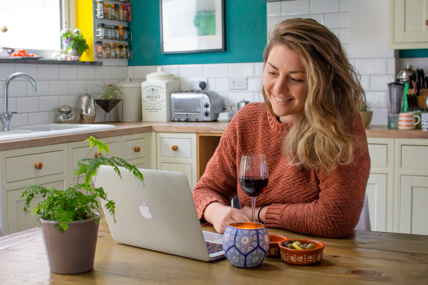 Lady on Laptop with Wine in Kitchen